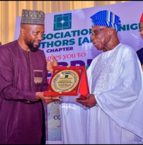 *National President of the Association of Nigerian Authors, (ANA), Dr Usman Akanbi, presenting a souvenir to former President Olusegun Obasanjo, in Abuja at the weekend.